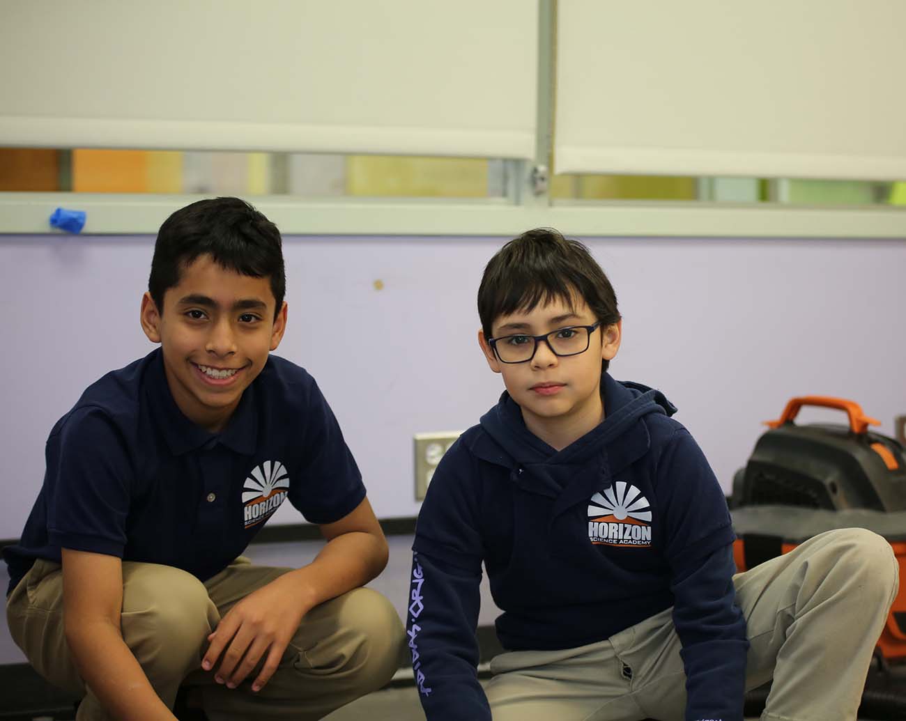 Teacher or school staff member warmly interacting with a student outside