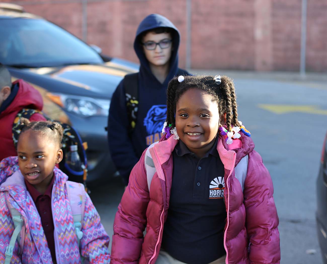Smiling children together outdoors.